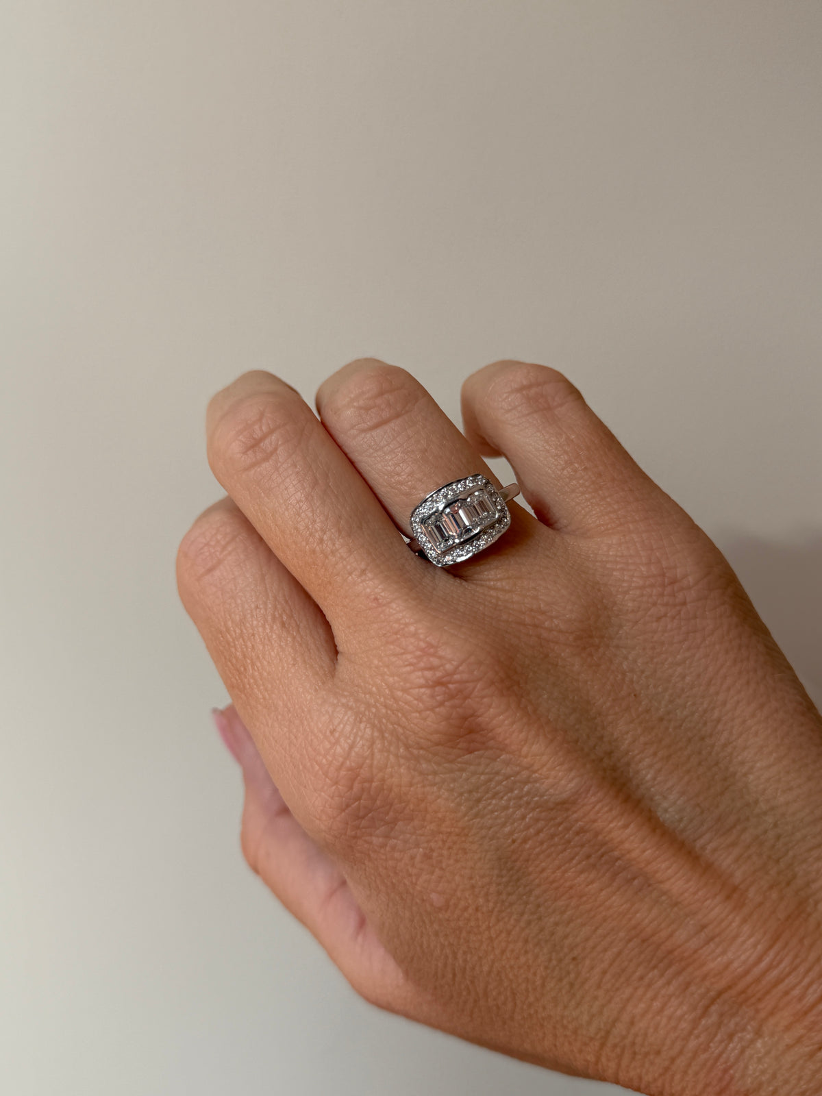 18CT WHITE GOLD EMERALD CUT DIAMOND HALO TRILOGY RING